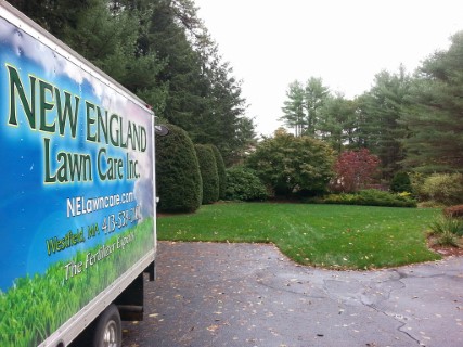 this is a photo of a new england lawn care truck parked next to an overseeding, southampton ma
